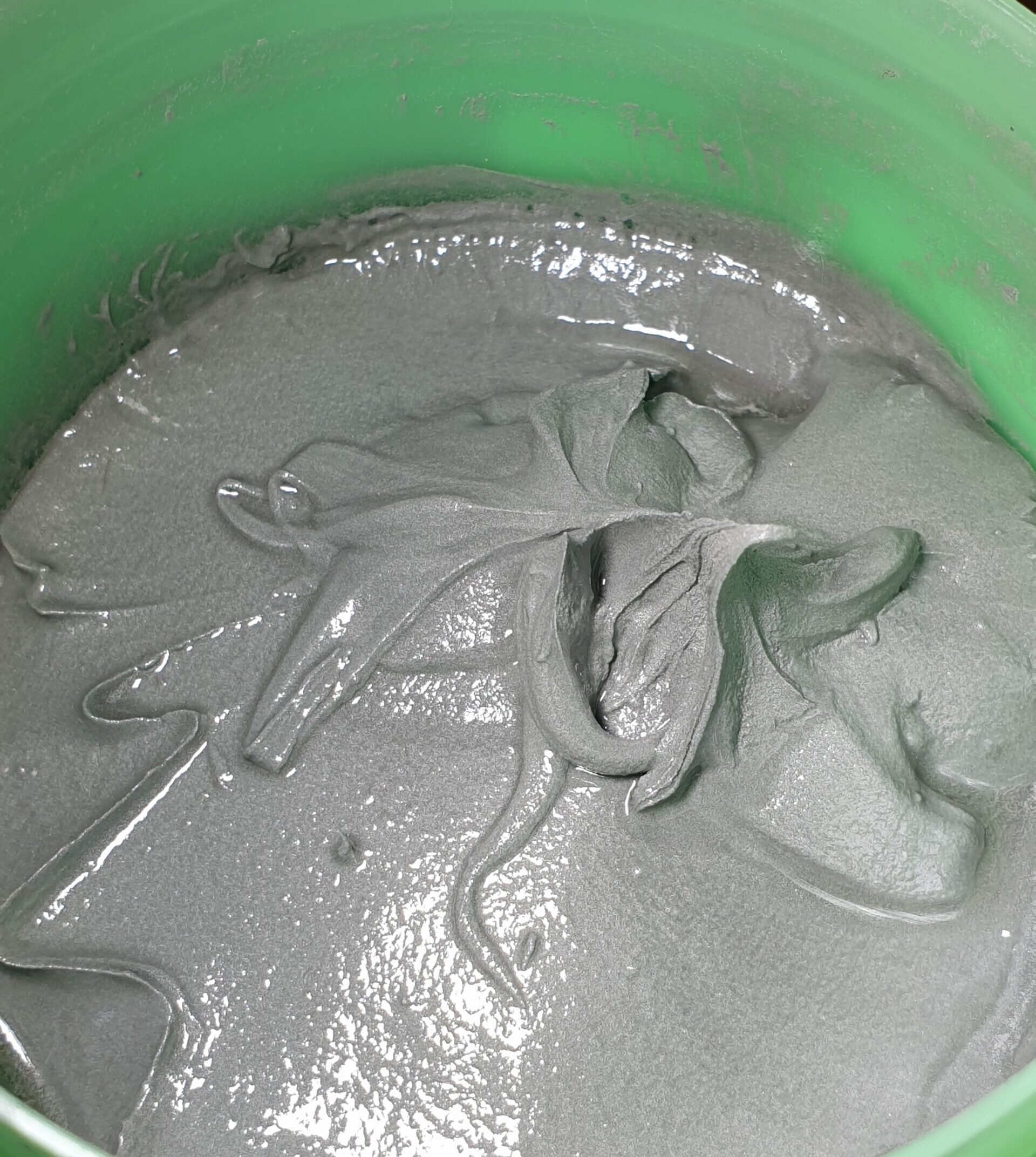 A big green tub of grey solder paste